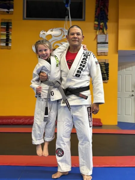 George Fujii and a young student in gi on the mat