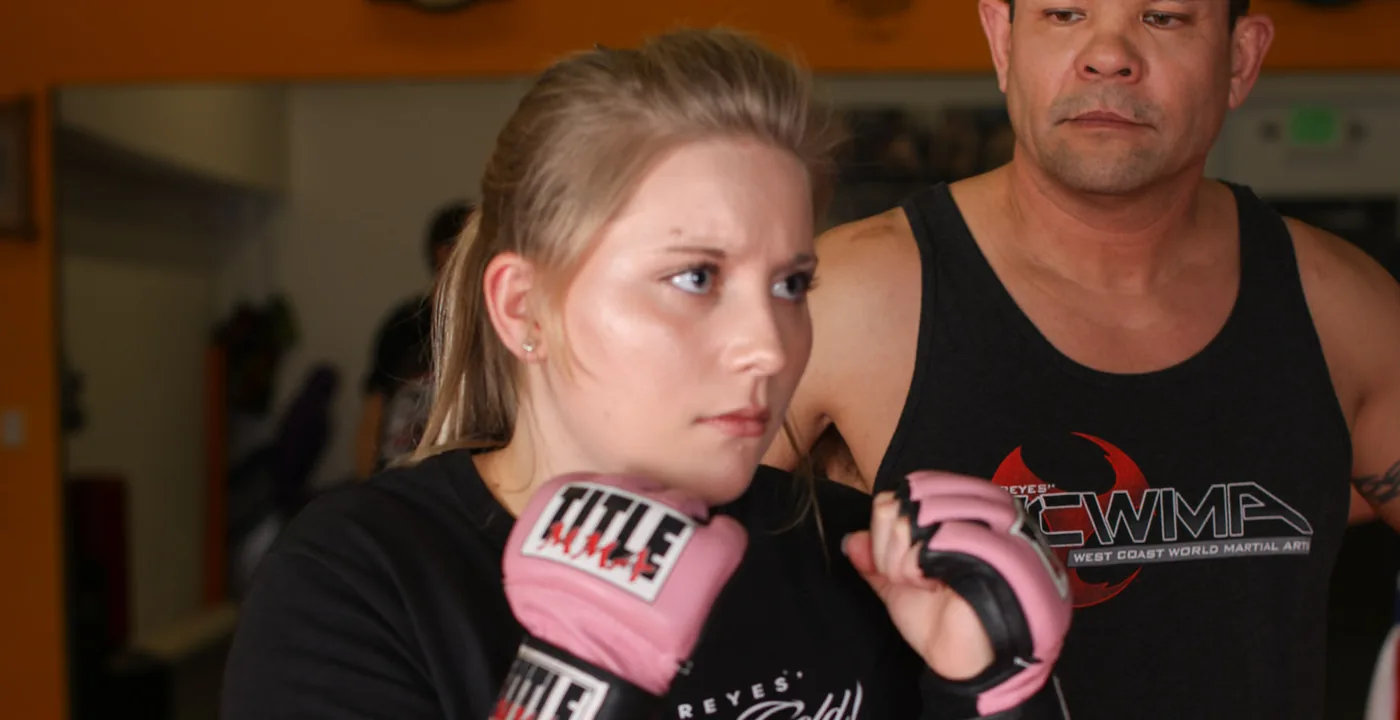 Kiki Fujii with MMA gloves up at West Coast Martial Arts