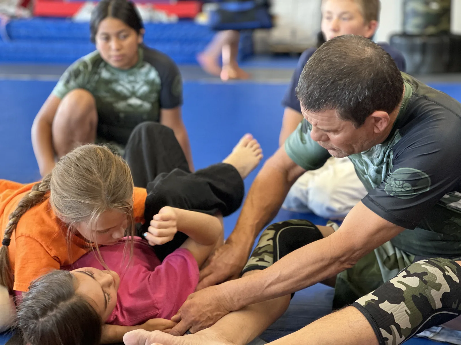 Instructor demonstrating a technique to a group of kids at West Coast Martial Arts